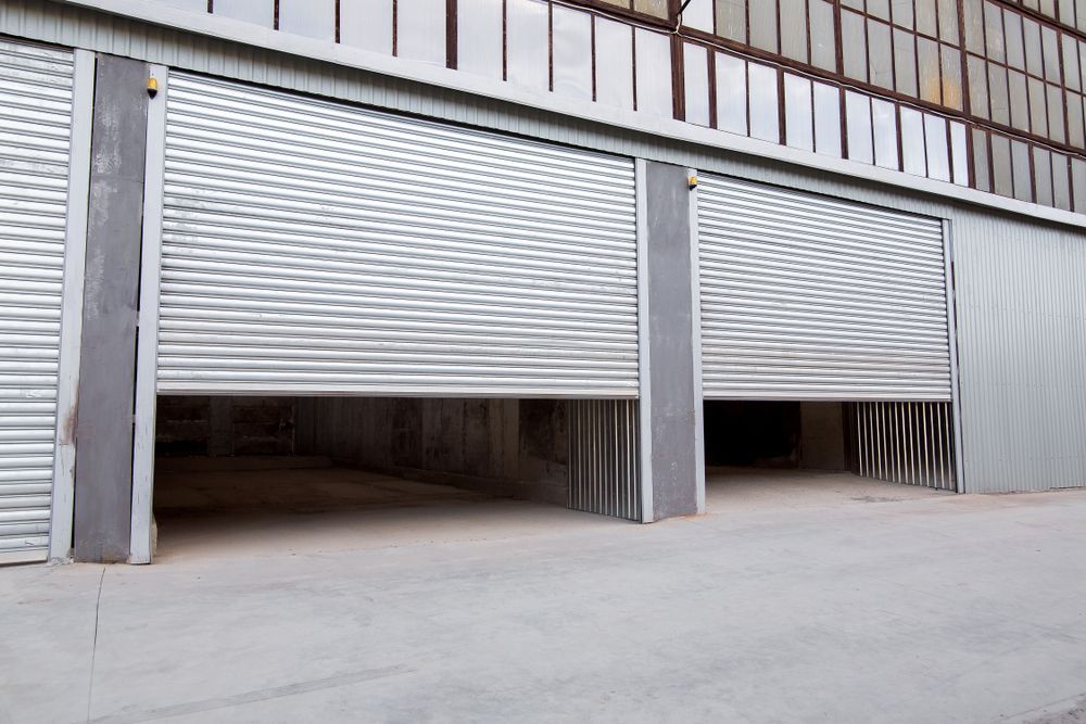 Grey Roller Shutter Doors On A Commercial Building, Fully Open — Ulladulla Blinds & Home Improvements In Ulladulla, NSW