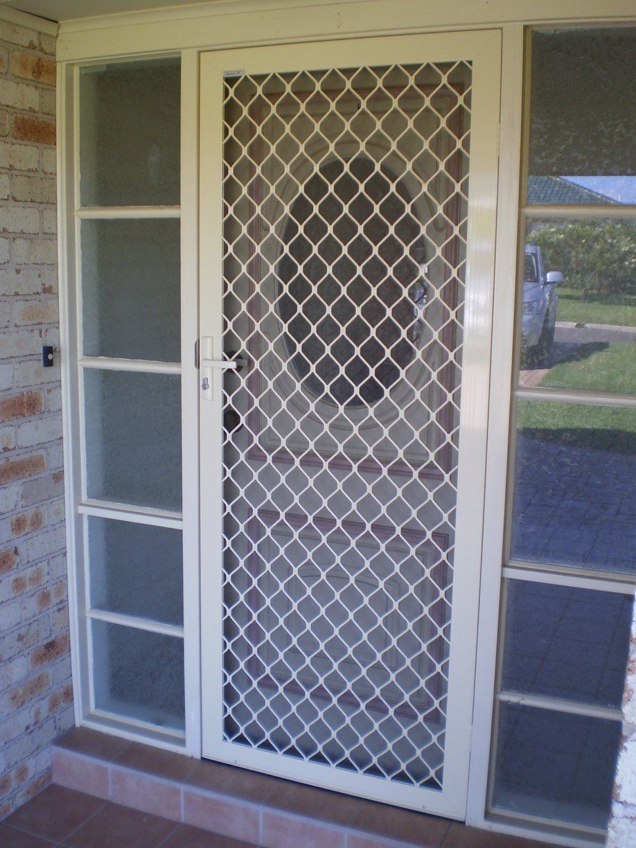 A White Door With A Diamond Pattern On It — Ulladulla Blinds & Home Improvements In Ulladulla, NSW