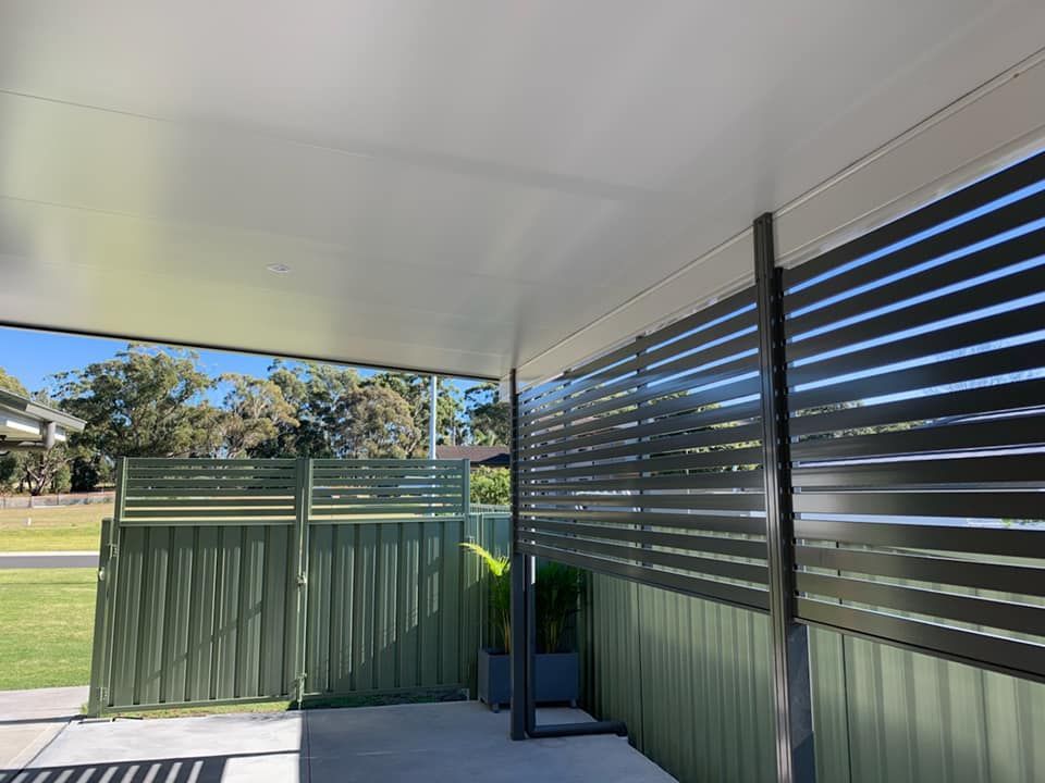 A Modern Slatted Fence, Shielding A Backyard From View — Ulladulla Blinds & Home Improvements In Ulladulla, NSW