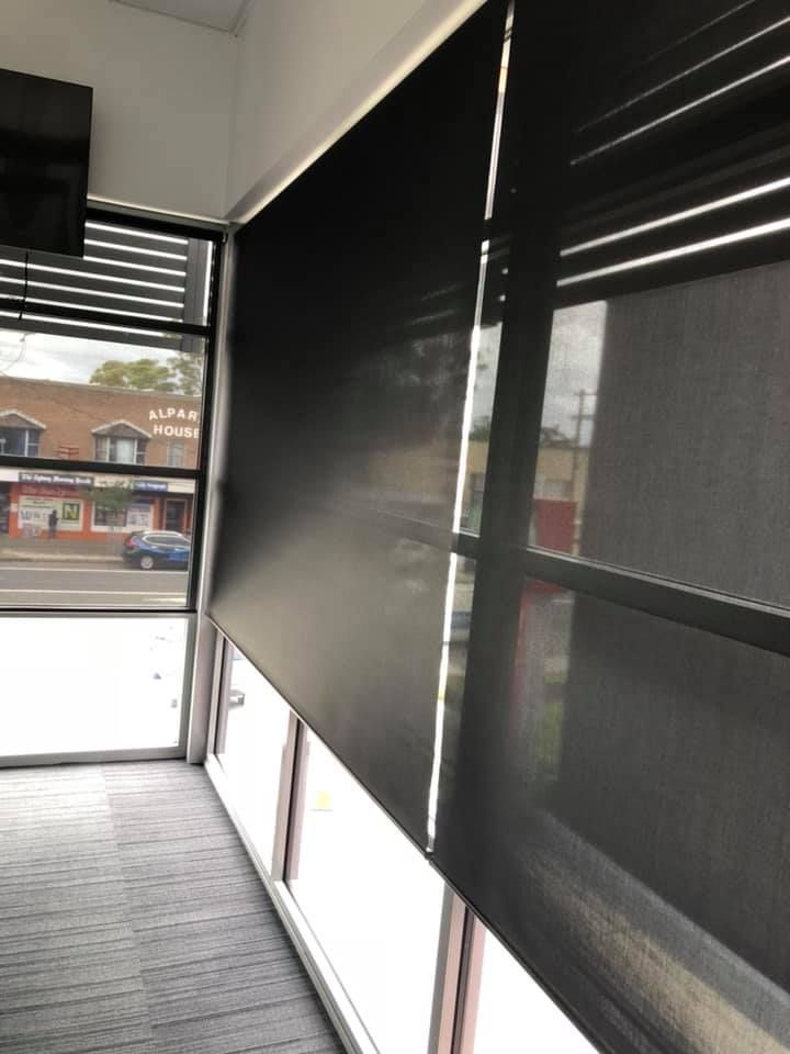 A Room With A Lot Of Windows And Black Blinds — Ulladulla Blinds & Home Improvements In Ulladulla, NSW