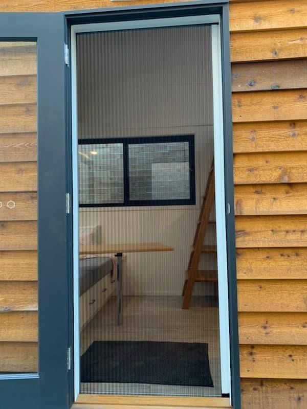 A Retractable Fly Screen Door, Open Position, On A Tiny House — Ulladulla Blinds & Home Improvements In Ulladulla, NSW