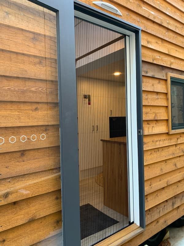A Hinged Fly Screen Window, Open Position, On A Tiny House — Ulladulla Blinds & Home Improvements In Ulladulla, NSW