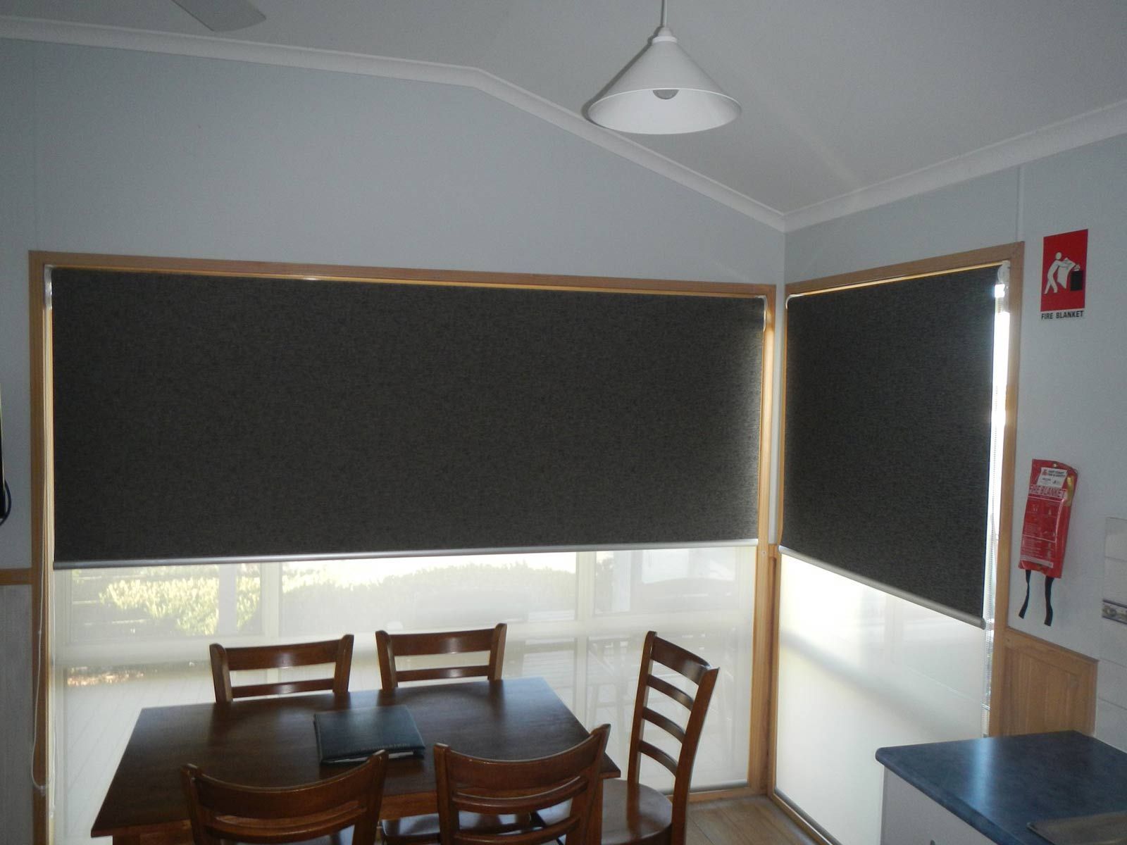 A Dining Room With A Table And Chairs And A Fire Extinguisher — Ulladulla Blinds & Home Improvements In Ulladulla, NSW
