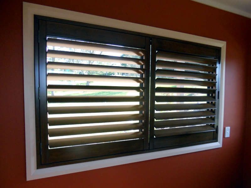 Dark Brown Plantation Shutters On A Window — Ulladulla Blinds & Home Improvements In Ulladulla, NSW
