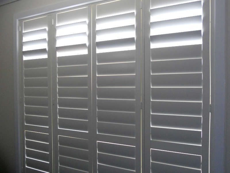 White Plantation Shutters Closed On A Large Window — Ulladulla Blinds & Home Improvements In Ulladulla, NSW