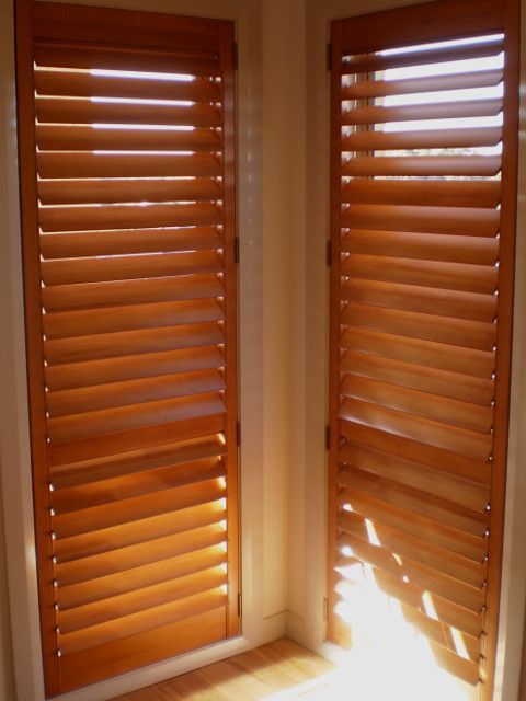 A Pair Of Wooden Shutters On A Window In A Room — Ulladulla Blinds & Home Improvements In Ulladulla, NSW