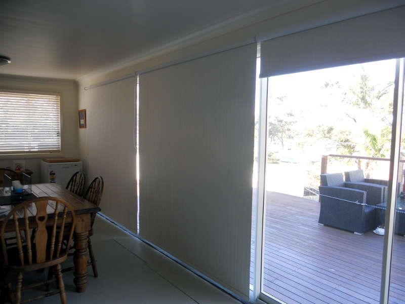 Roller Blinds Providing Shade And Privacy In A Dining Room — Ulladulla Blinds & Home Improvements In Ulladulla, NSW