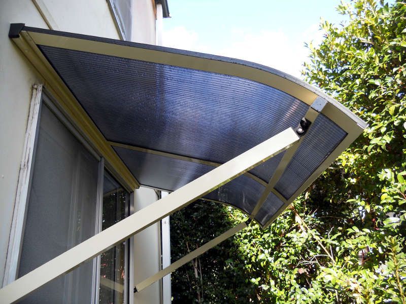 Clear Window Canopy Shielding A Window From Rain And Sun — Ulladulla Blinds & Home Improvements In Ulladulla, NSW