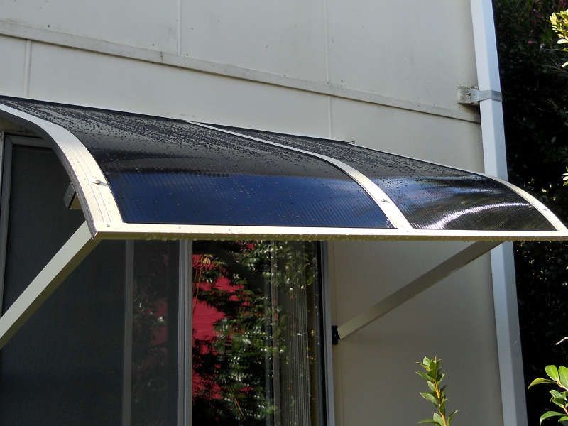 A Window With A Black Awning Over It — Ulladulla Blinds & Home Improvements In Ulladulla, NSW