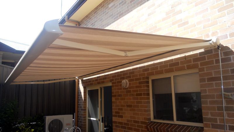 Beige Retractable Awning, Partially Extended, Over A Patio — Ulladulla Blinds & Home Improvements In Ulladulla, NSW