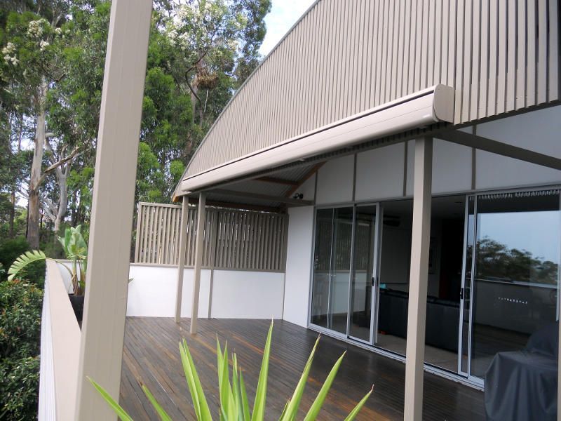 A Large Building With A Large Deck In Front Of It — Ulladulla Blinds & Home Improvements In Ulladulla, NSW