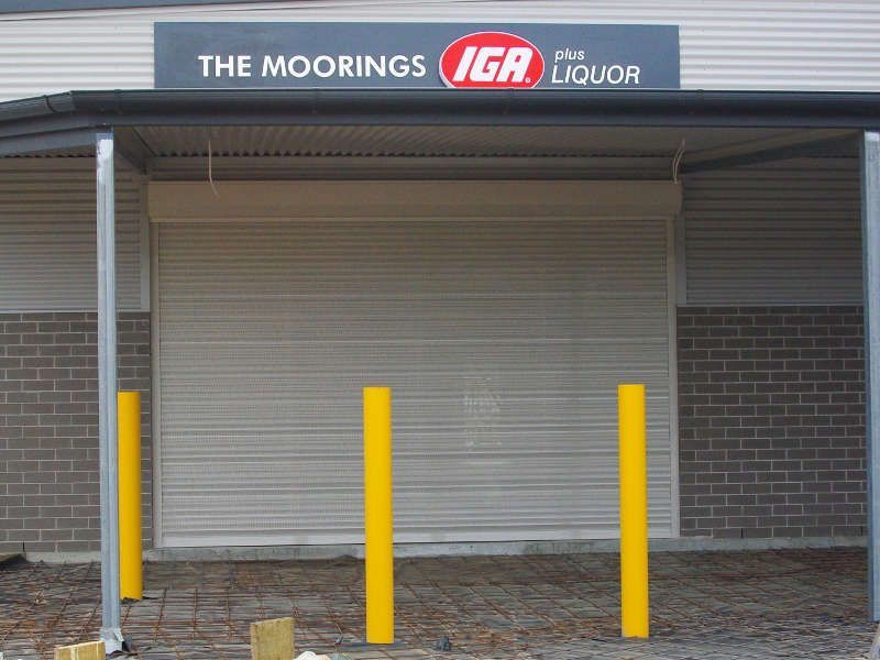 White Roller Shutter, Partially Raised, Over A Shopfront — Ulladulla Blinds & Home Improvements In Ulladulla, NSW