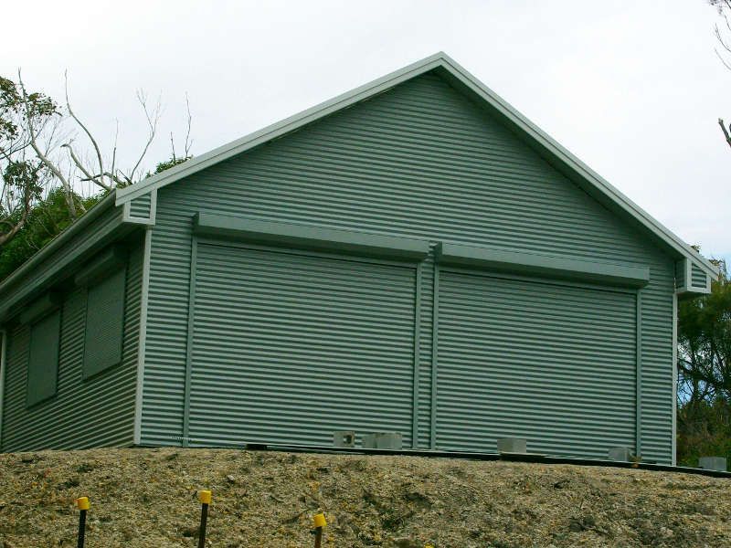 Grey Roller Shutter Doors On A Garage, Partially Open — Ulladulla Blinds & Home Improvements In Ulladulla, NSW