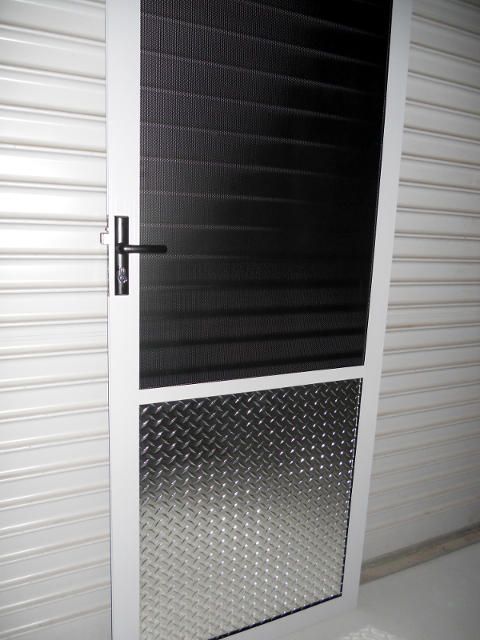 A Hinged Fly Screen Door, Closed Position, On A Porch — Ulladulla Blinds & Home Improvements In Ulladulla, NSW