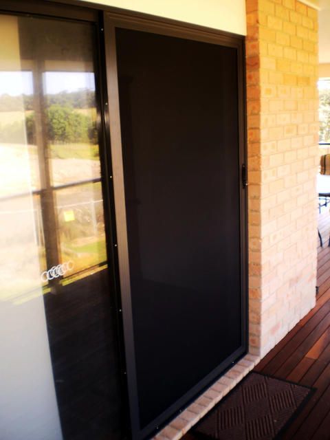 A Sliding Glass Door With A Fly Screen — Ulladulla Blinds & Home Improvements In Ulladulla, NSW