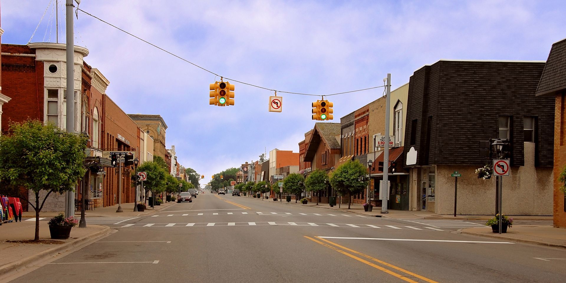 The front door of a house with a porch and plants in front of it.