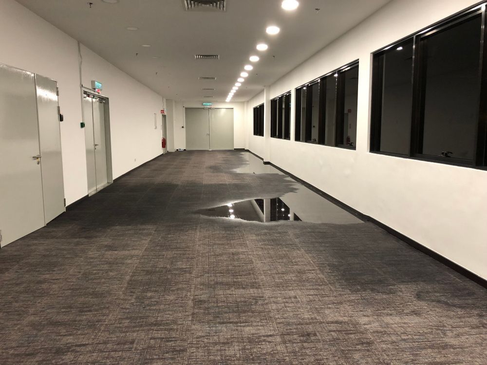 A long hallway with a puddle of water on the floor