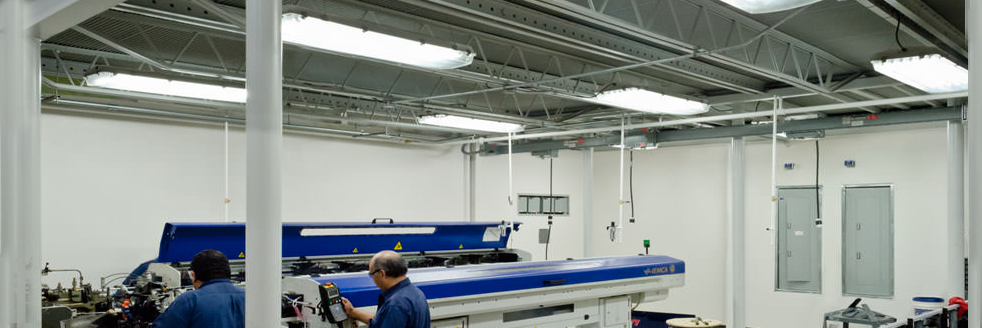 A man is working on a machine in a factory.