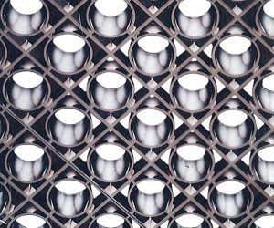 A close up of a rubber mat with holes in it on a white background.