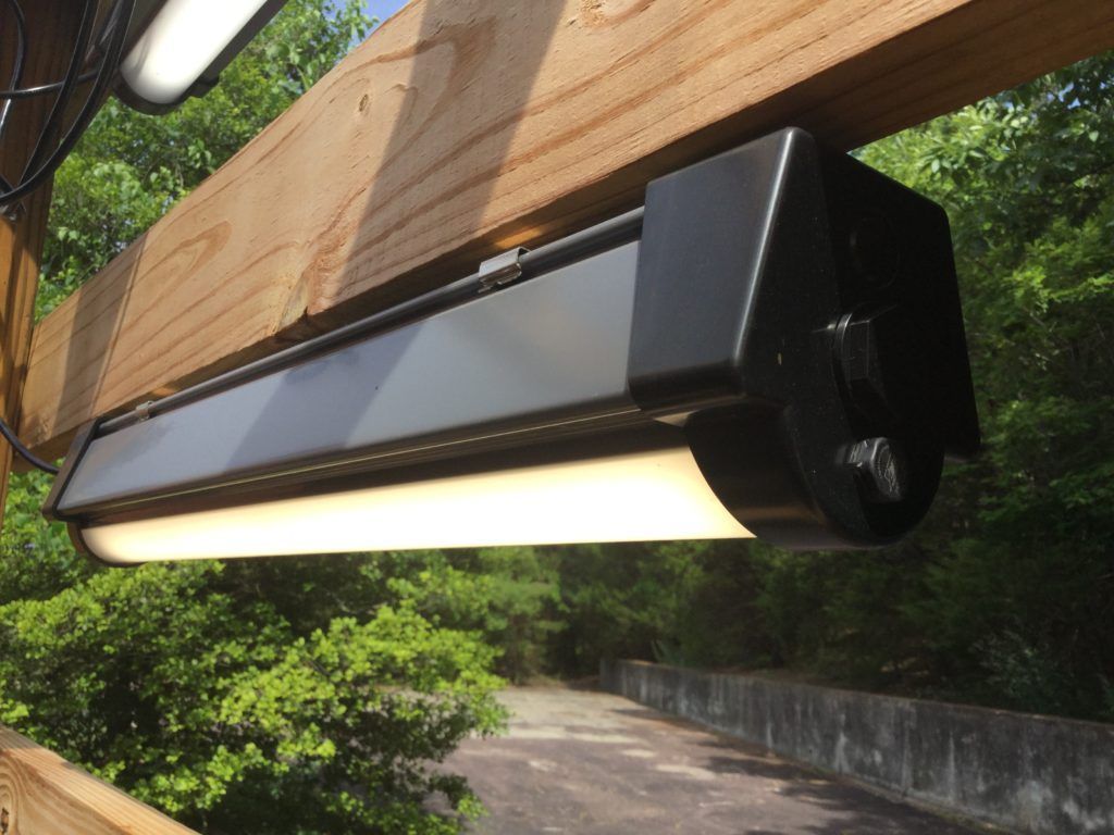 A light that is hanging from a wooden beam