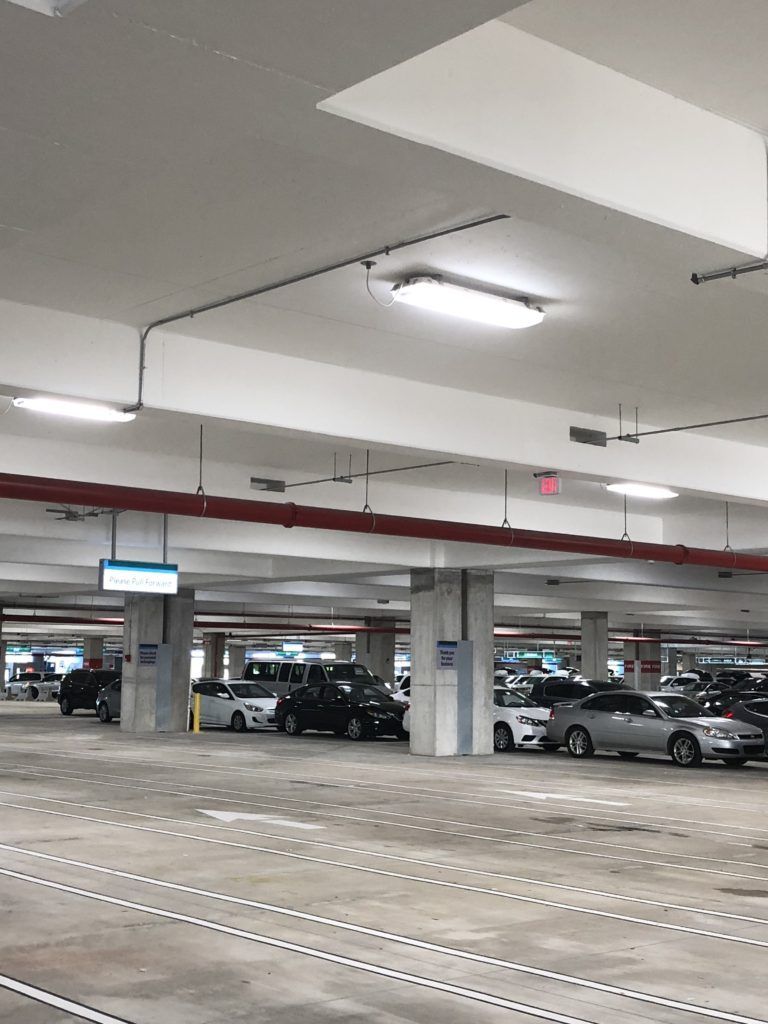 A parking garage with a lot of cars parked in it