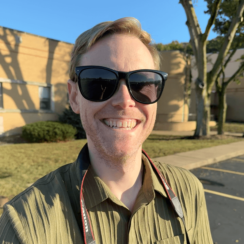 A cartoon of a woman holding a camera and smiling