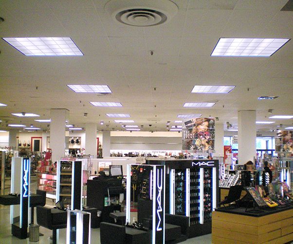 A large mac store with a lot of lights