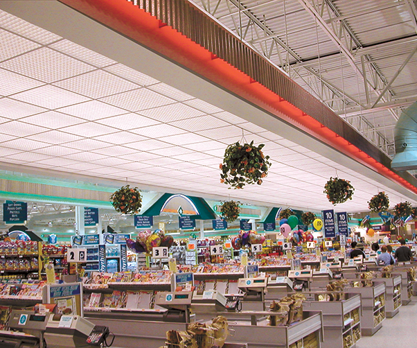 The inside of a grocery store with flowers hanging from the ceiling
