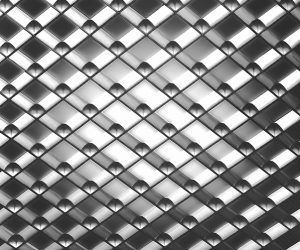 A close up of a metal surface with a checkered pattern.