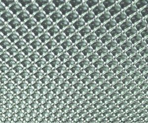 A close up of a metal surface with a diamond pattern.