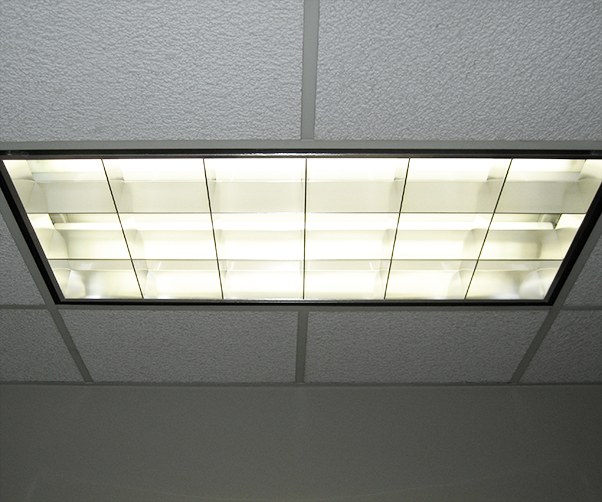 A light fixture is hanging from the ceiling in a room.