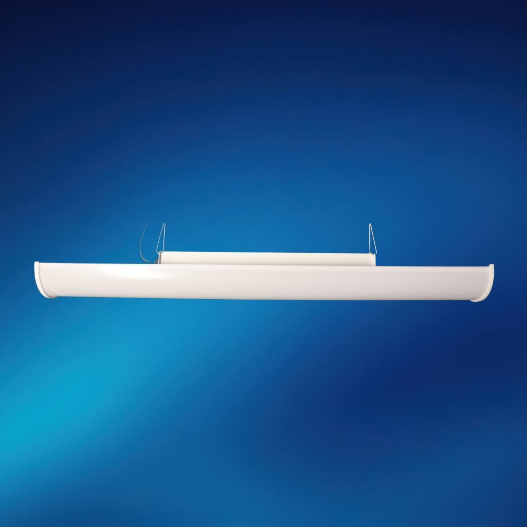 A white light fixture is hanging from the ceiling on a blue background.