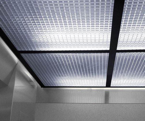 A close up of a glass ceiling in an elevator