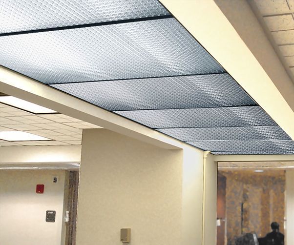 A hallway with a fire alarm on the wall