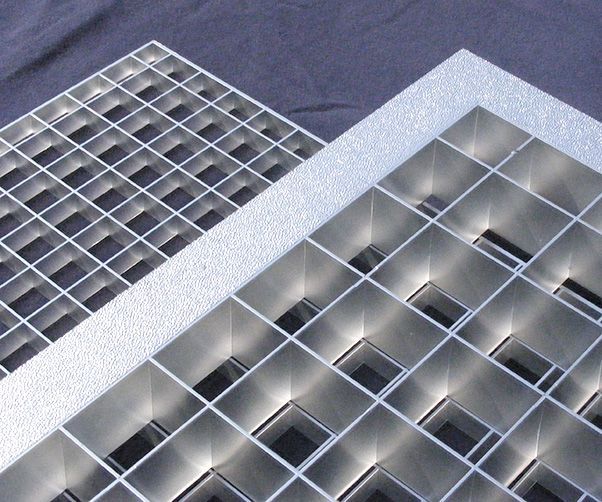 A close up of a metal grate that looks like a building
