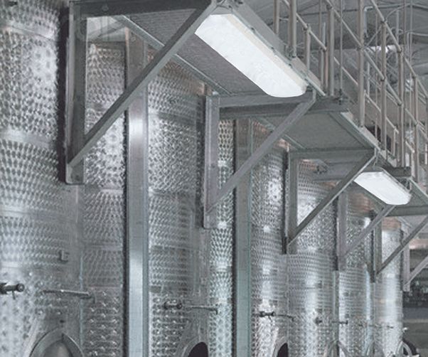 A row of stainless steel tanks in a factory