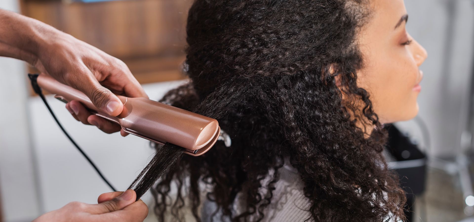 Black women getting hair straightened