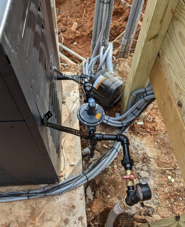 A bunch of pipes are connected to a box on the ground