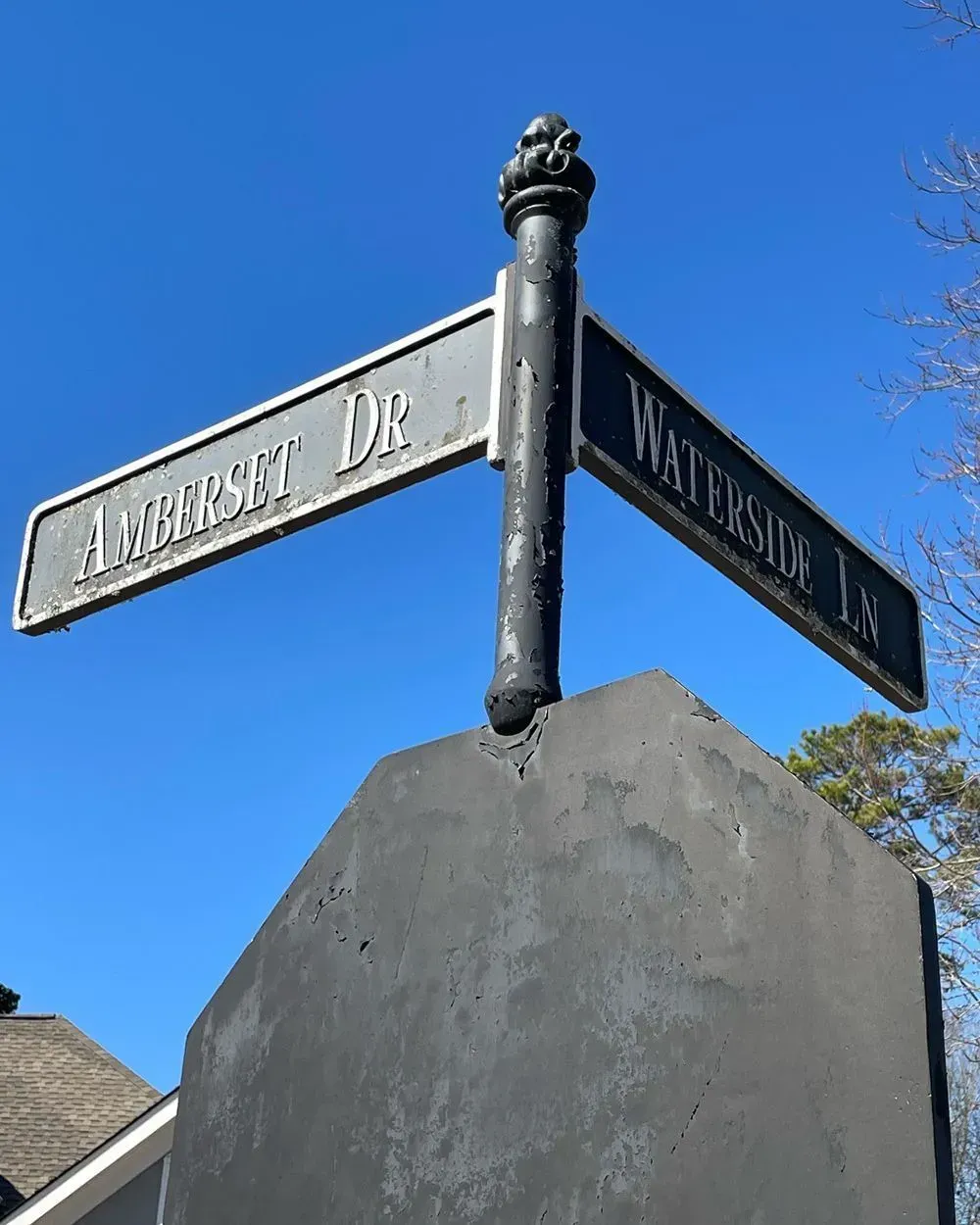 Black street signs labeled 