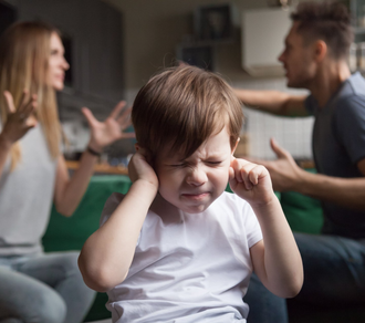 kid plugging ears while parents scream at each other