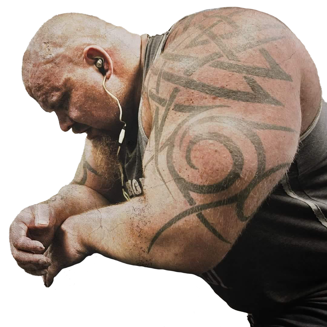 A man with a tattoo on his arm is wearing ear buds