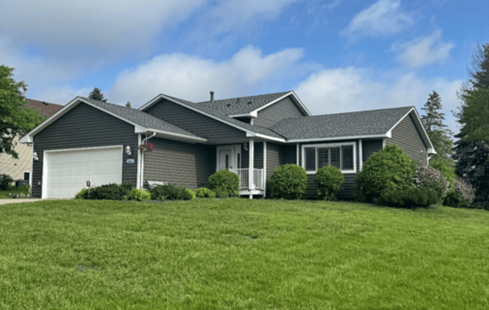 A grey Saint Paul, MN home exterior featuring an updated roof, siding, and windows from Bruggeman Exteriors