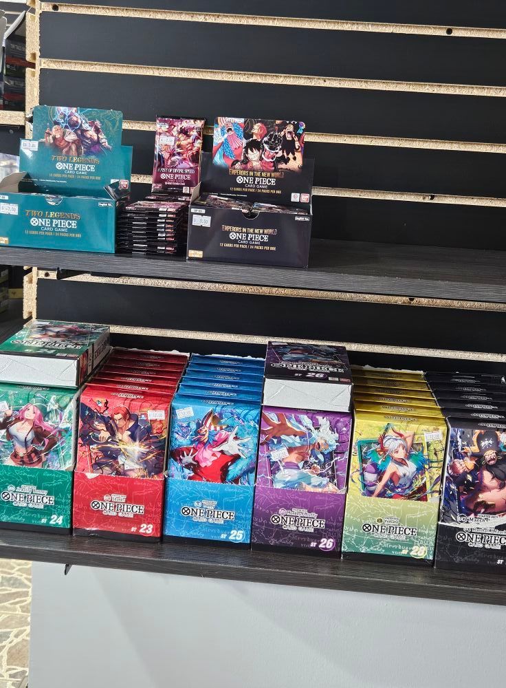 Shelves displaying various boxes of trading card games, featuring colorful art and branding.