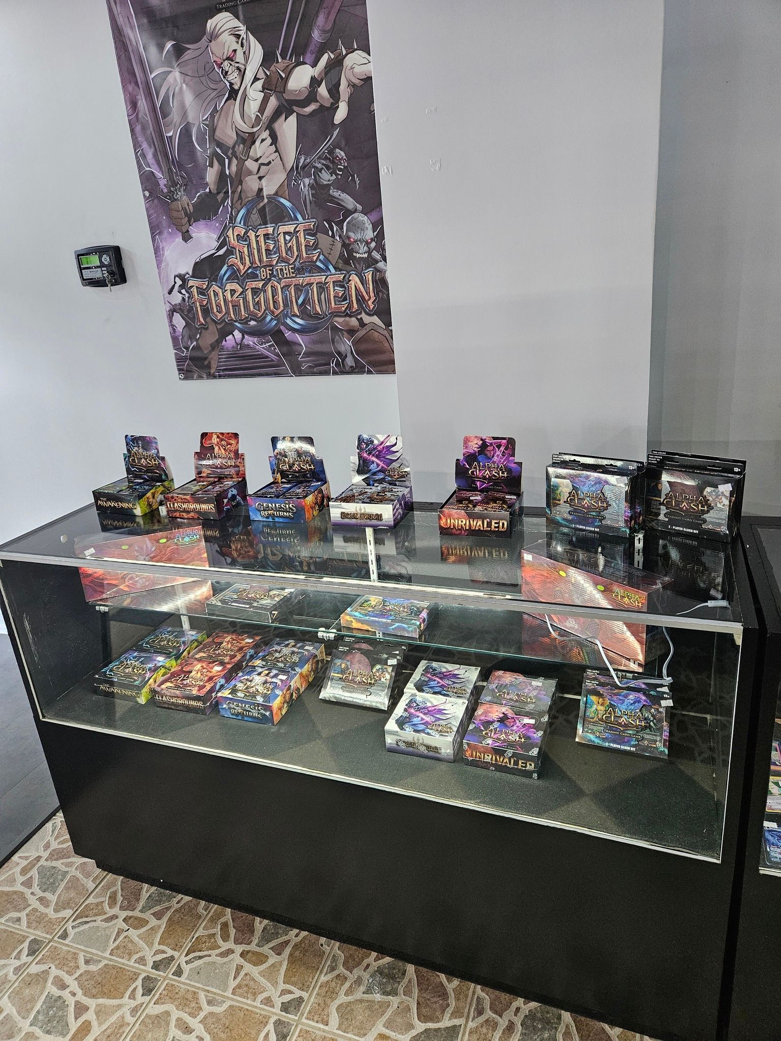 Display case with tabletop game boxes; store setting, Warhammer banner in background.