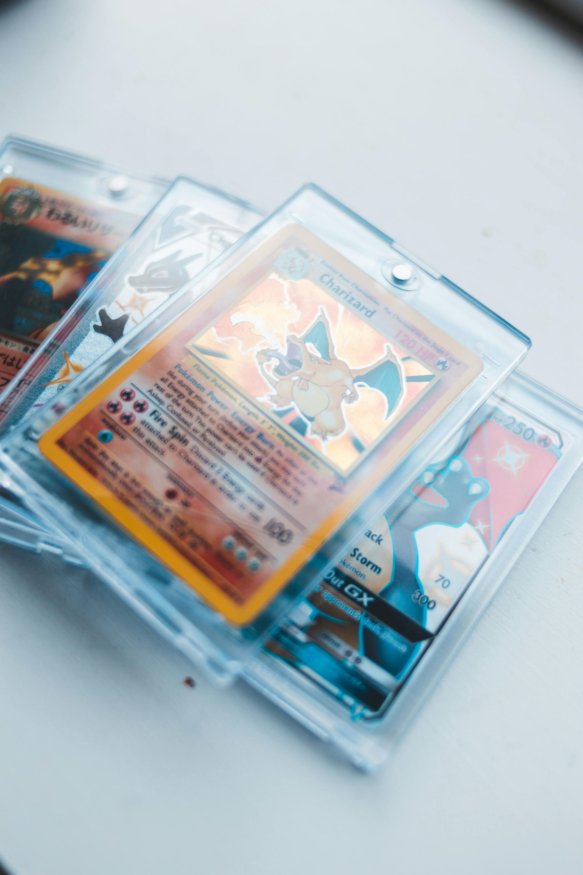 Charizard Pokémon cards in protective sleeves.