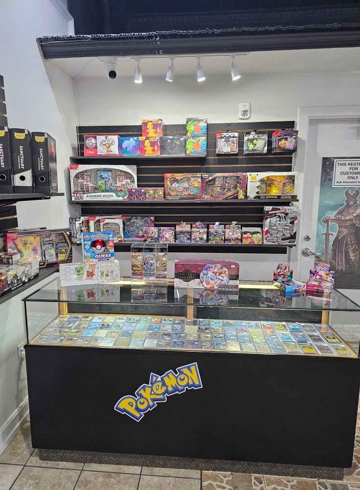 Pokemon card shop display with cards in glass case and products on shelves.