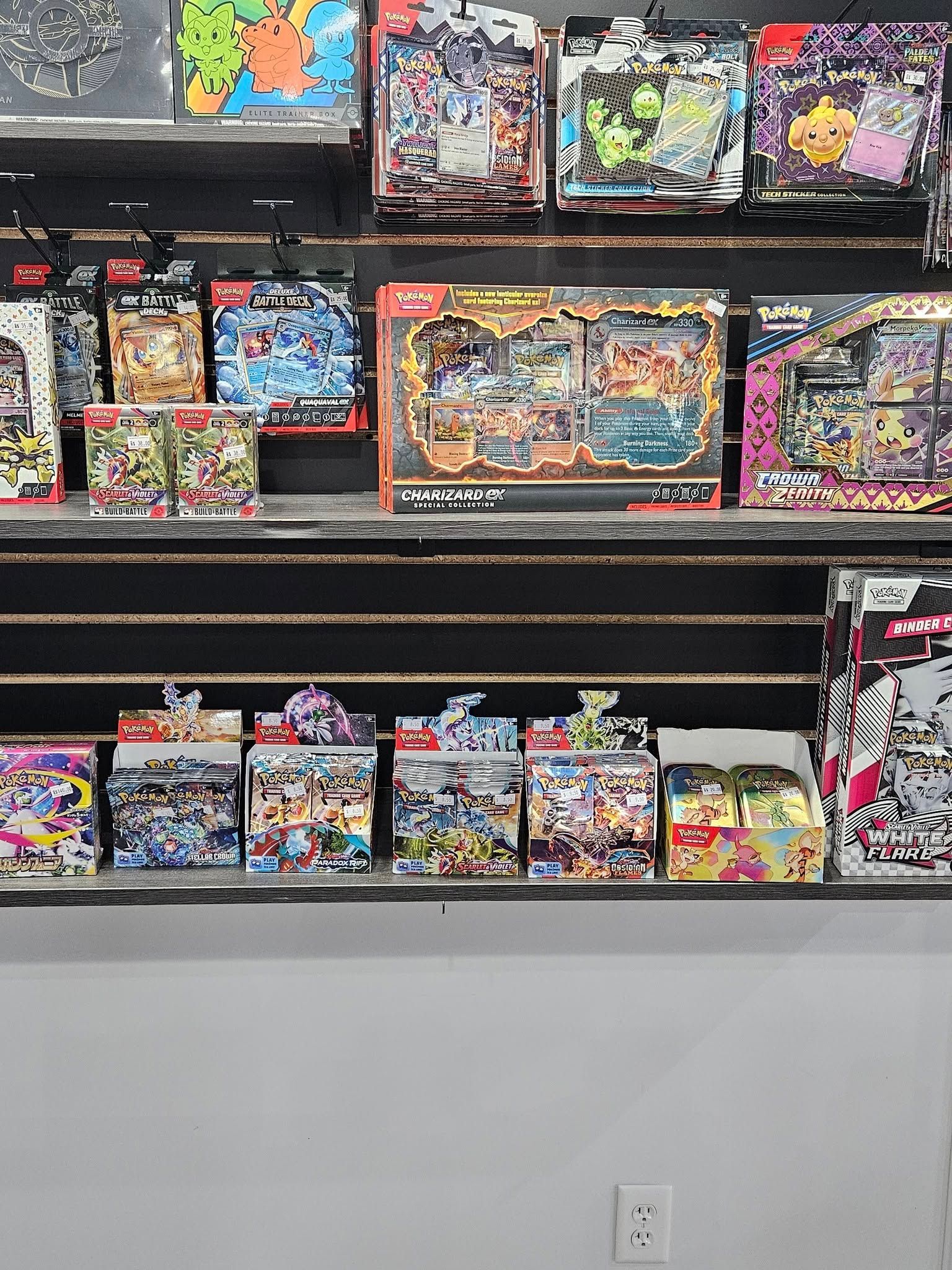 Shelves stocked with trading card game products in a store.
