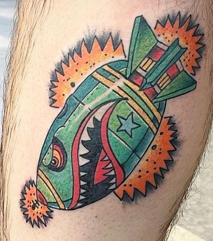 A man has a tattoo of a rocket on his leg