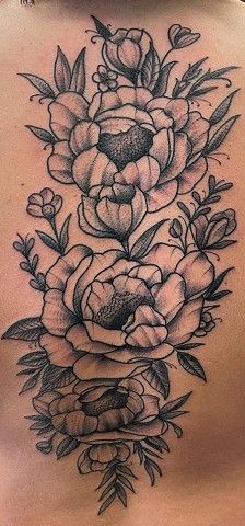 A close up of a tattoo of flowers on a person 's back.