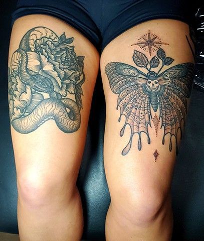 A woman has two tattoos on her thighs , a snake and a moth.